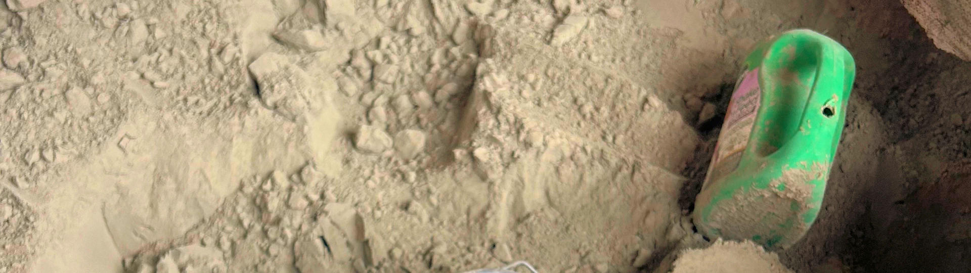 Scoop inside a bulk gaylord container of portland cement